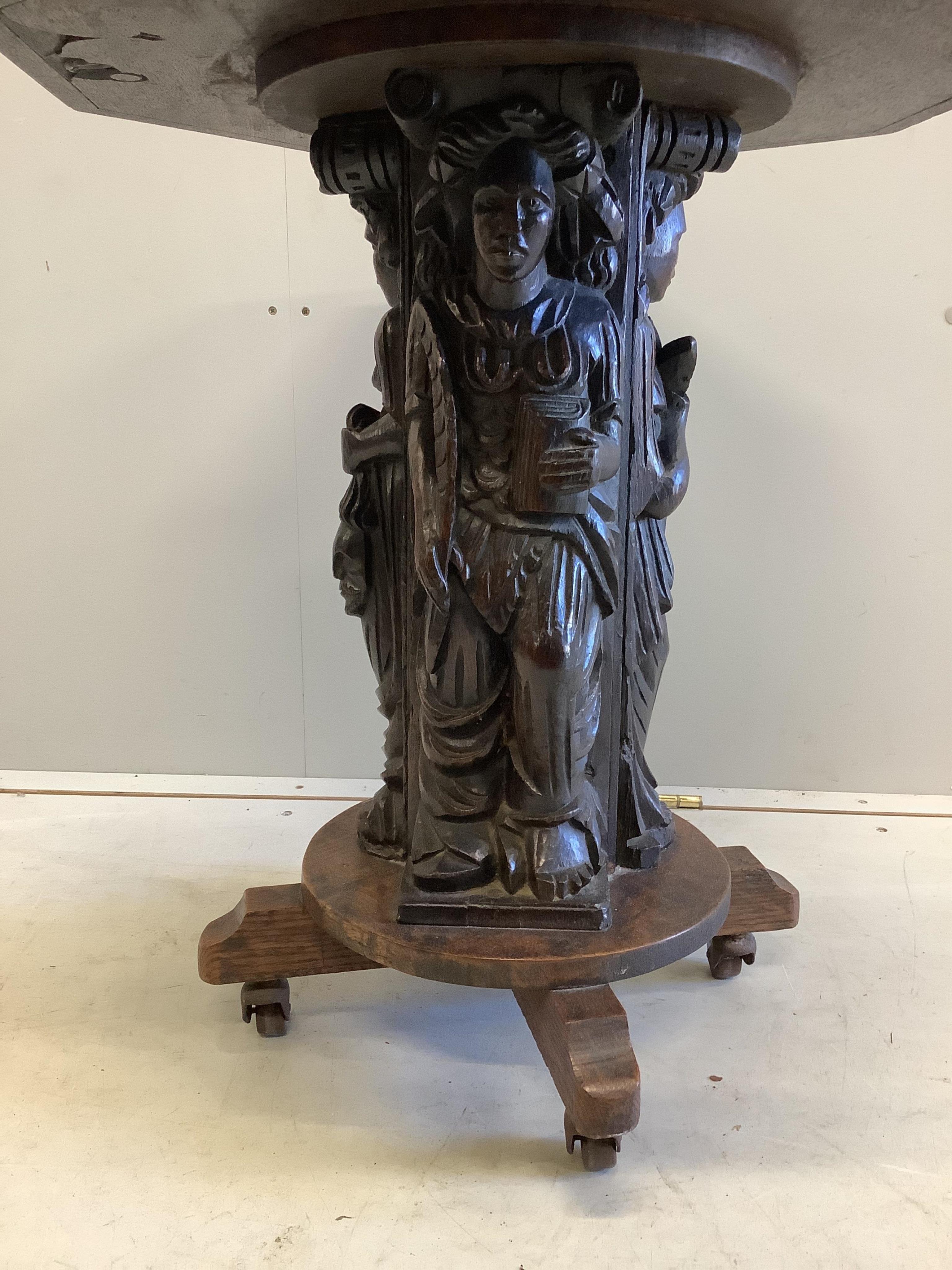 A 19th century octagonal oak side table with figural column, incorporates old timber, width 55cm, depth 55cm, height 59cm
